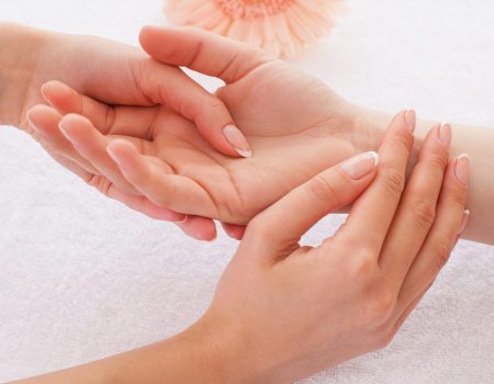 Shiatsu. Close-up of massage therapist massaging hand of female customer